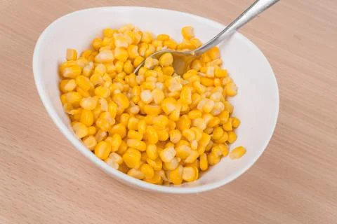 Yellow corn in a bowl on the table Stock Photos