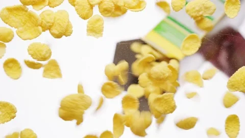 Yellow corn flakes falling from package on a transparent background, bottom view Stock Footage 155208059