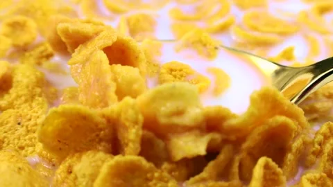 Yellow corn flakes with white milk in the spoon close up. Breakfast cereals 스톡 동영상 245610853