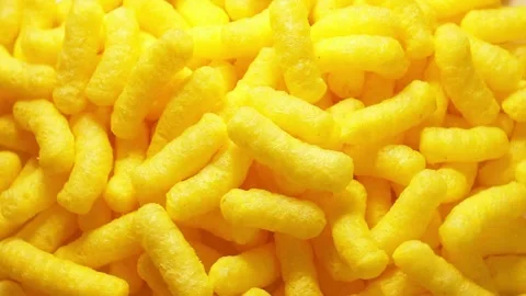 Yellow corn sticks falling and mixing on a rotating table, close up. Corn b.. Stock Footage 338212334