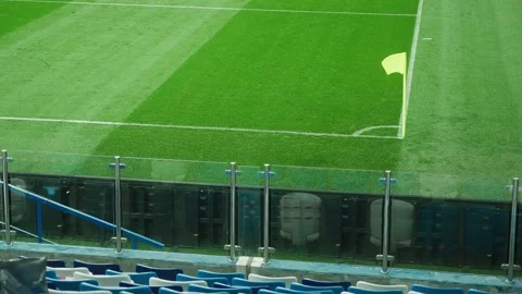 A yellow corner flag waving in the wind on a football field Stock Footage 142816683