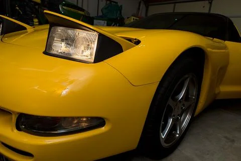 Yellow Corvette from the Front Side with Headlight Activated Stock-Fotos