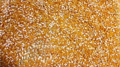 Yellow cracked corn grain creating a full frame background texture, commonly Stock Photos