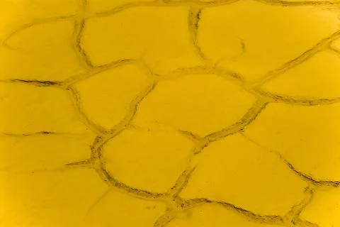 Yellow cracked mud Stock Photos