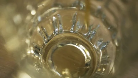 Yellow craft beer is poured into an empty glass closeup and bubbling slowmotion Stock Footage 116908448