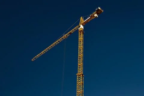 Yellow crane on the background of the blue sky Stock Photos