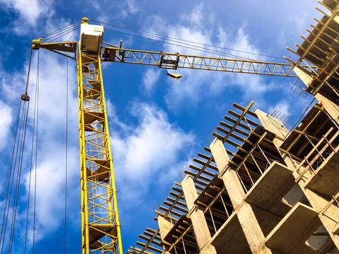 Yellow crane on a construction Stock Photos
