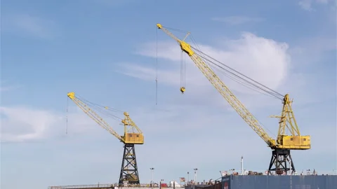 Yellow cranes against sky Stock Footage 297922630