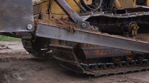 Yellow crawler tractor is going in reverse Stock Footage 168832637