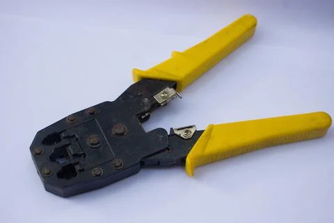 Yellow crimping pliers on a white background Stock Photos