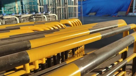 Yellow Crowd Control Barrier Close up stacked in an outdoor commercial area Video stock 342782281