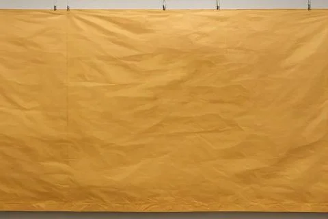 Yellow crumpled mackup for text, background billboard on white wall. Ilustración de archivo