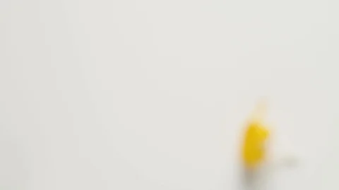 Yellow cup on a white background with Easter eggs. female hand puts a cup with Stock-Footage 108197239