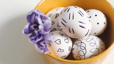Yellow cup on a white background with Easter eggs. easter eggs in a yellow cup Stock Footage 109404067