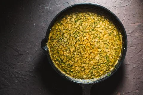 Yellow curry paste on a cast-iron frying pan. Indian food Stock Photos