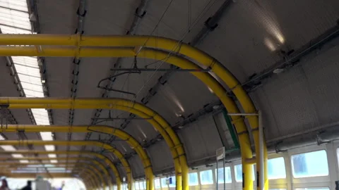 Yellow curved structural beams and industrial ceiling design inside airport.. Stock Footage 314782086