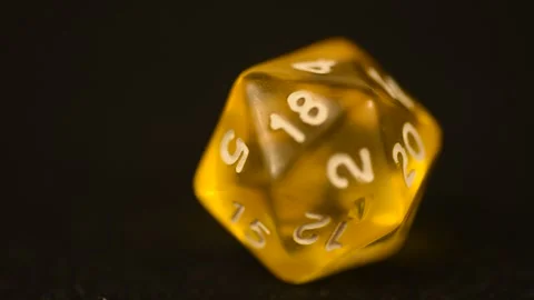 Yellow d20 macro footage with rotating die and black background Stock Footage 251242010