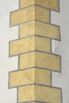 Yellow decorative masonry pattern on building corner Foto stock