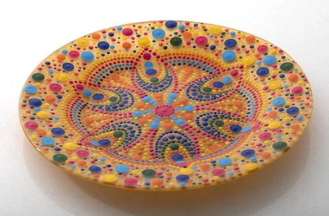 Yellow decorative plate with a mandala pattern Stock-Fotos