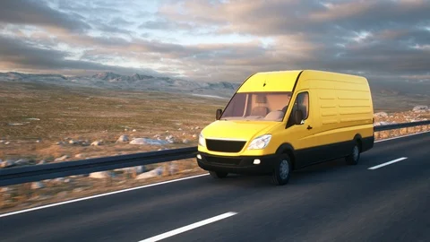 Yellow delivery van driving along a desert road into the sunset Stock Footage
