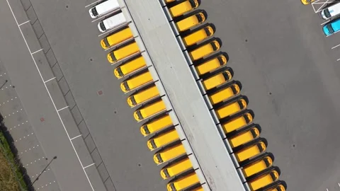 Yellow delivery vans parked in a logistics center hub Stock Footage 341874604