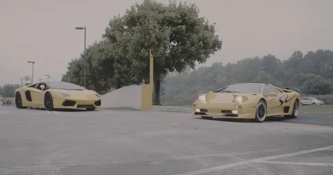 Yellow Diablo SV pulling into parking lot Stock Footage 105122670
