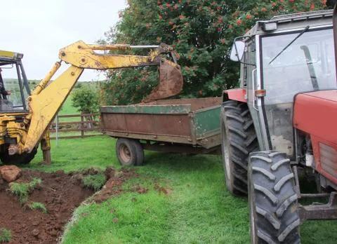 Yellow Digger digging out foundations for an extinction  Foto stock