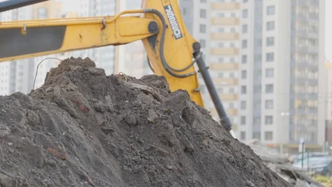 Yellow digger works on building. Construction machinery, ground works. Stock Footage 129870325