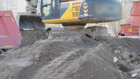 Yellow digger works on building. Construction machinery, ground works. Video stock 129870347