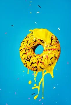 Yellow donut on a blue background Stock Photos