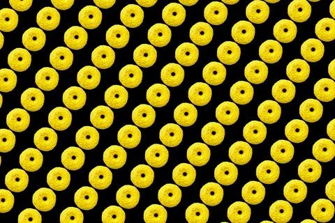 Yellow donuts on black background small size Stock-Fotos