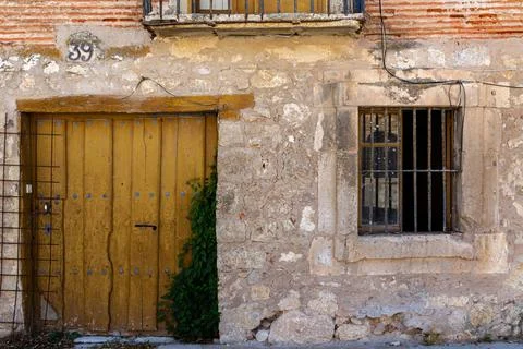 Yellow door on a stone facade Stock Photos