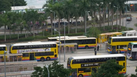 Yellow double-decker buses on almost empty street in Hong Kong, China Stock Footage 144855360