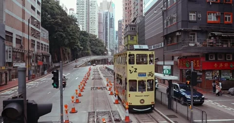 Yellow Double Decker Tram and Red Taxi on Busy Hong Kong Street Видео 331066636