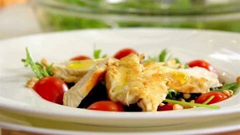Yellow dressing pours over fresh chicken and tomato salad Video stock 333876081