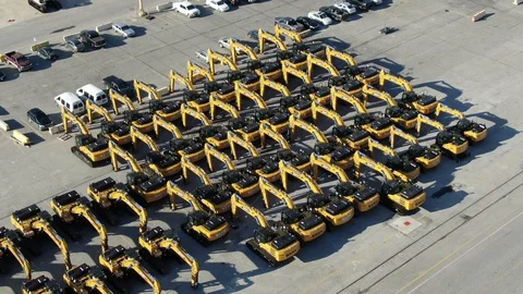 Yellow earthmoving machines in rows beside the river port at Savannah, Georgia 104512423