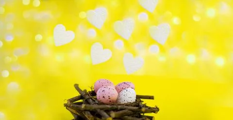 Yellow easter background with white foam hearts bokeh in blur Stock Photos