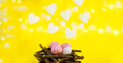 Yellow easter background with white foam hearts bokeh in blur Stock Photos