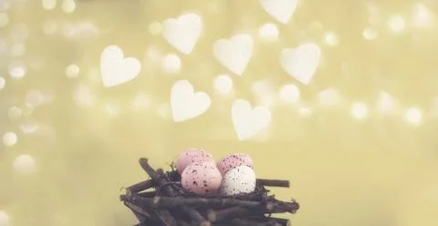 Yellow easter background with white foam hearts bokeh in blur Stock Photos