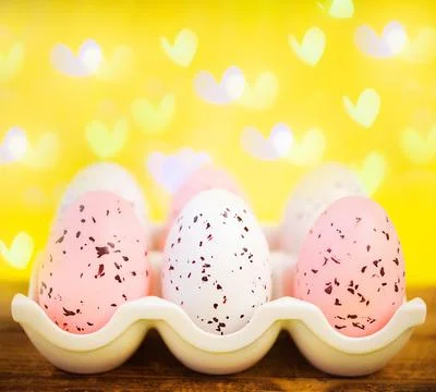 Yellow easter background with white foam hearts bokeh in blur Stock Photos