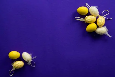 Yellow easter decorative eggs on a dark purple background Stock Photos