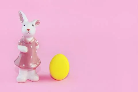 Yellow easter egg and ceramic bunny Stock Photos