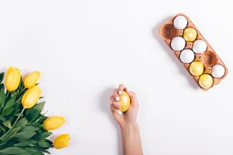 Yellow easter egg in a female hand Stock Photos