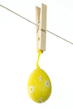 Yellow easter egg hanging from a line Stock Photos