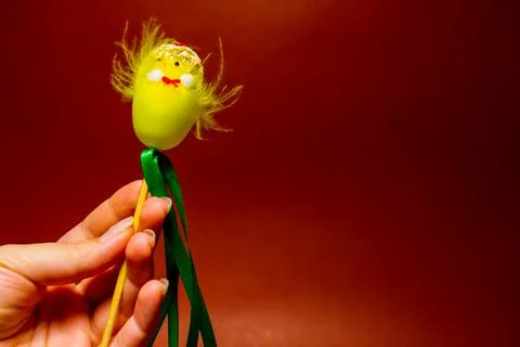 The yellow easter egg with toy chicken in hand of woman 스톡 사진