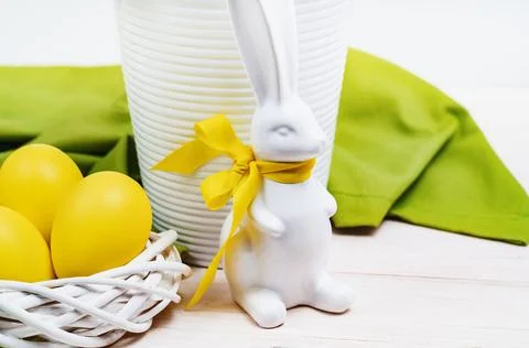 Yellow Easter eggs and blooming Daffodils in a pot Stock Photos