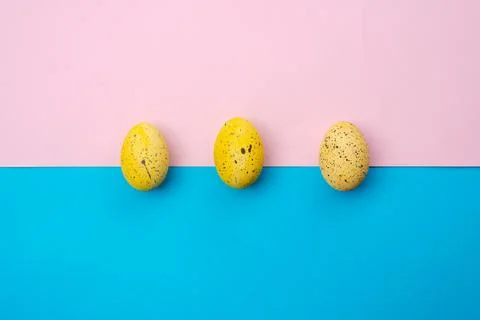 Yellow, easter eggs on a pink-blue background Stock Photos