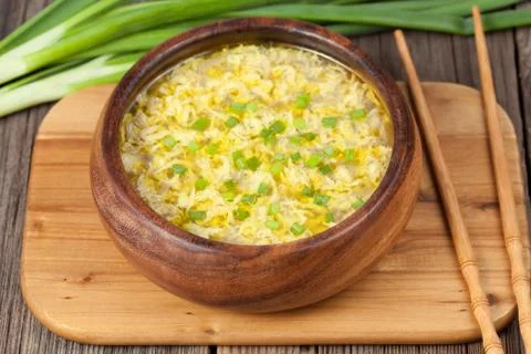 Yellow egg drop soup with chiken broth chinese healthy lunch Stock Photos