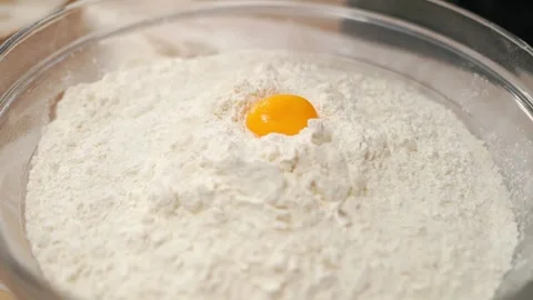 Yellow Egg Falls Into Flour Stock Footage 273501489