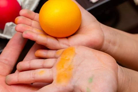 Yellow egg in hands for the Easter Stock Photos